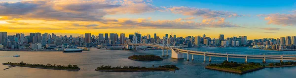 Panoramic Aerial view of Tokyo skylines with Rainbow bridge and tokyo tower over Tokyo bay in daytime from Odaiba in Tokyo city Kanto Japan. panorama photo of city in japan.