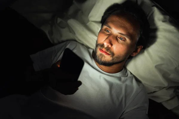 Young handsome and tired man with a beard cannot sleep and is wa Stock Image