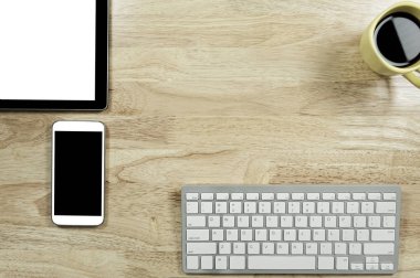 boş ekran akıllı telefonlar ve tablet Pc bilgisayar klavye ve bir fincan kahve kompozisyon kopya alanı metni ile ahşap Masaüstü