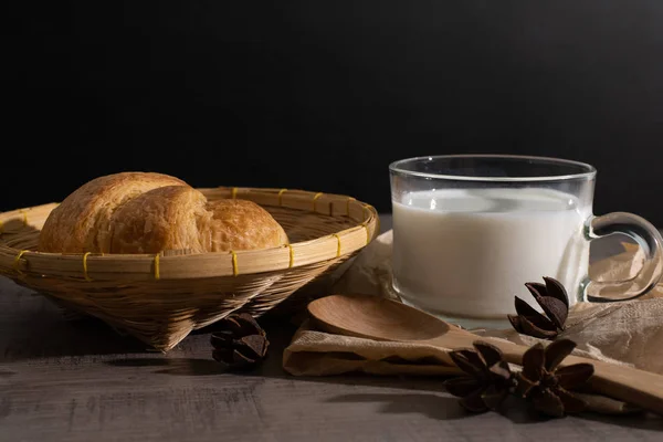 A set of croissant and cup of milk on the wooden table — Stock Photo, Image