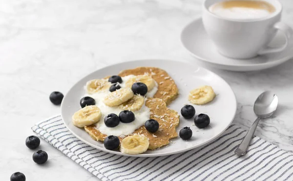 Healthy pancakes with fresh berry, fruits and yogurt. Summer breakfast concept.