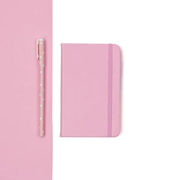 Flat lay of woman desk with notepad and pen on pink paper backgr — Stock Photo, Image