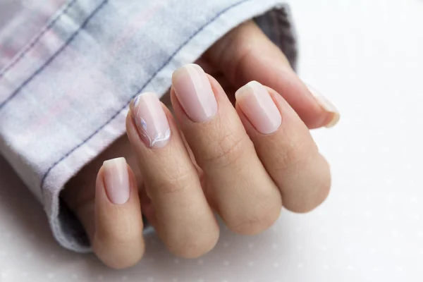 Beautiful groomed woman's hands with feminine nails on the light — Stock Photo, Image