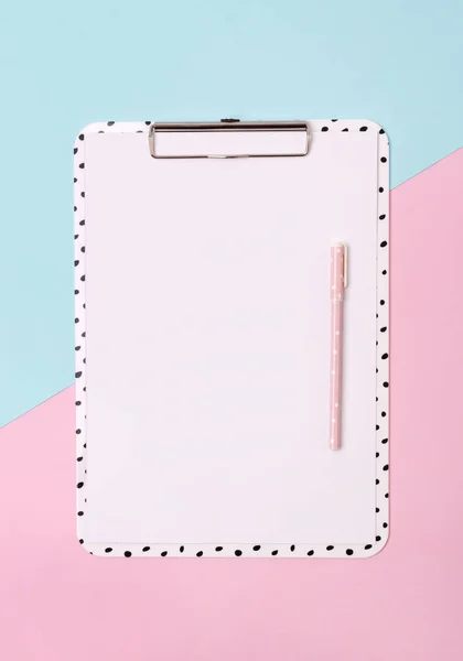 Clipboard with pen at creative pink and blue background. — Stock Photo, Image