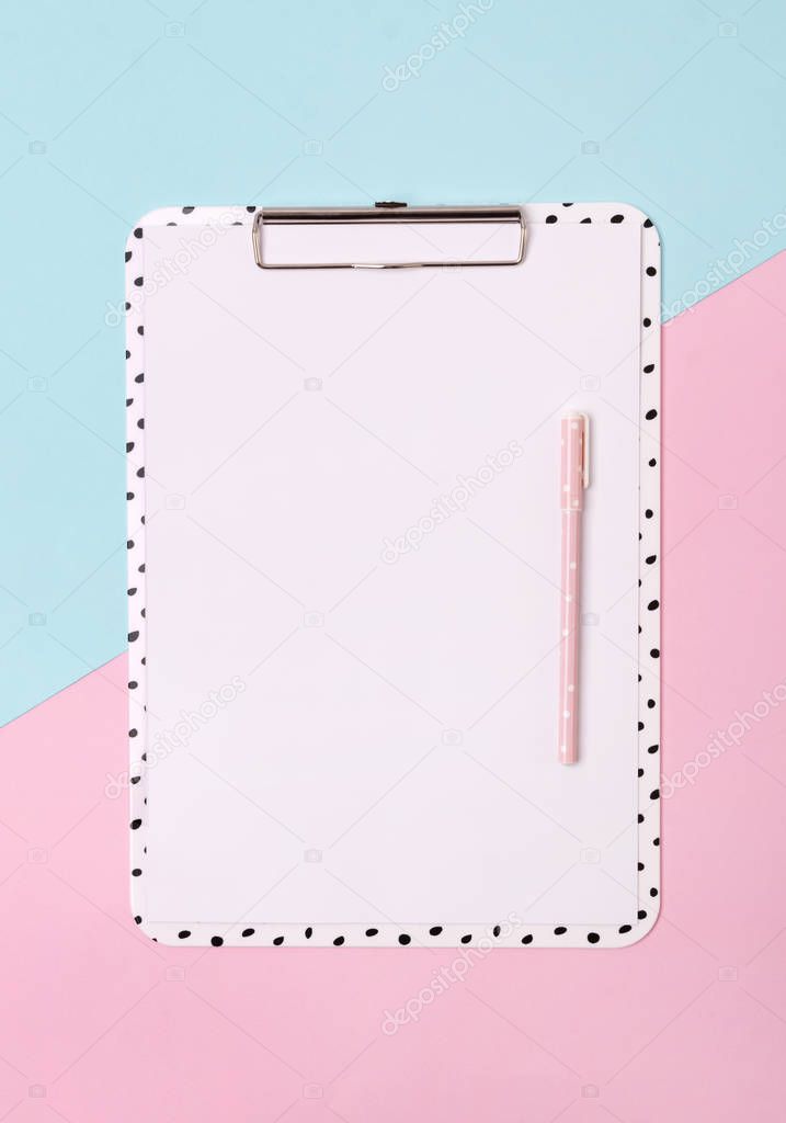 Clipboard with pen at creative pink and blue background.