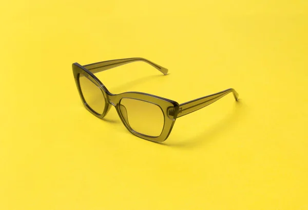 Gray modern fashionable sunglasses on yellow background. — Stock Photo, Image