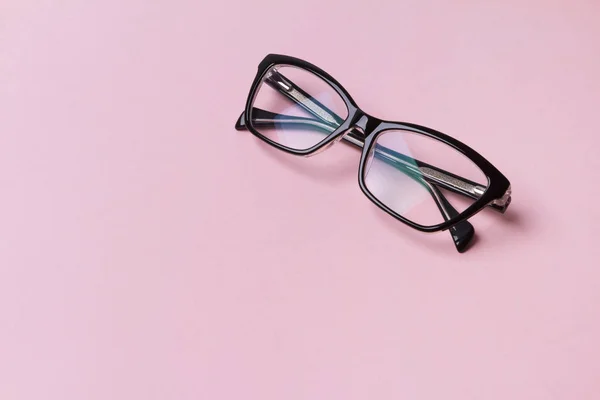 創造的なピンクの背景にスタイリッシュなファッショナブルなメガネ. — ストック写真