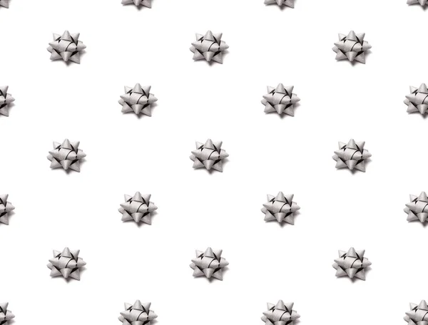 Seamless pattern with silver glitter gift bow isolated on white.