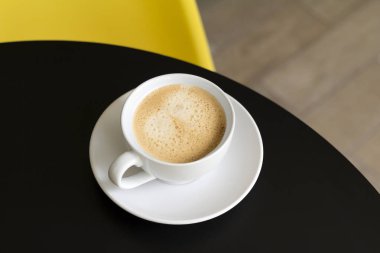 Mutfakta ya da kafede siyah masada beyaz bardakta kahve.