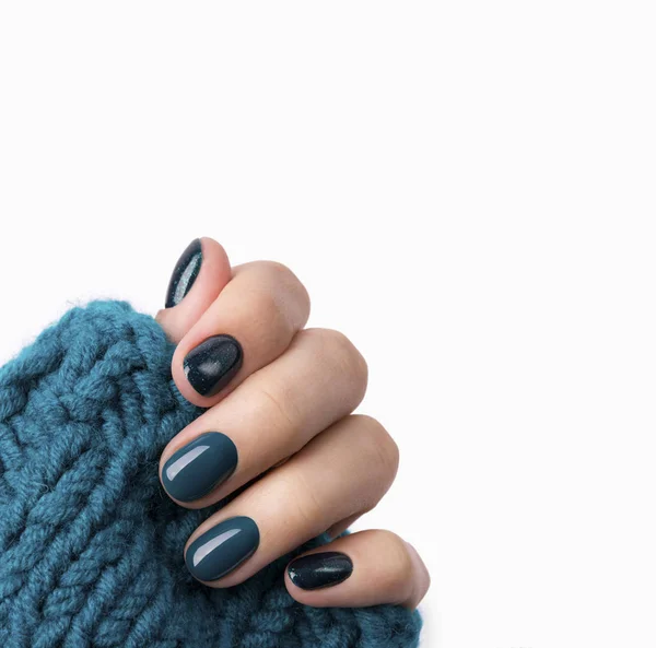 Manicured woman's hand in warm wool turquoise sweater — Stock Photo, Image