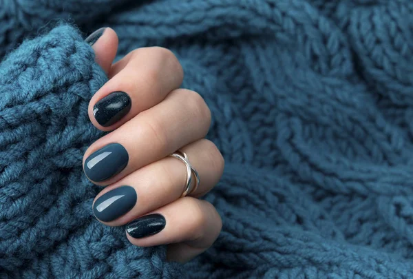 Manicured woman's hand in warm wool turquoise sweater — Stok fotoğraf