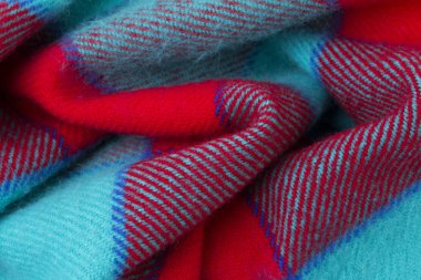Kırmızı kumaş ile örme turkuaz doku yakın. Yün örgü