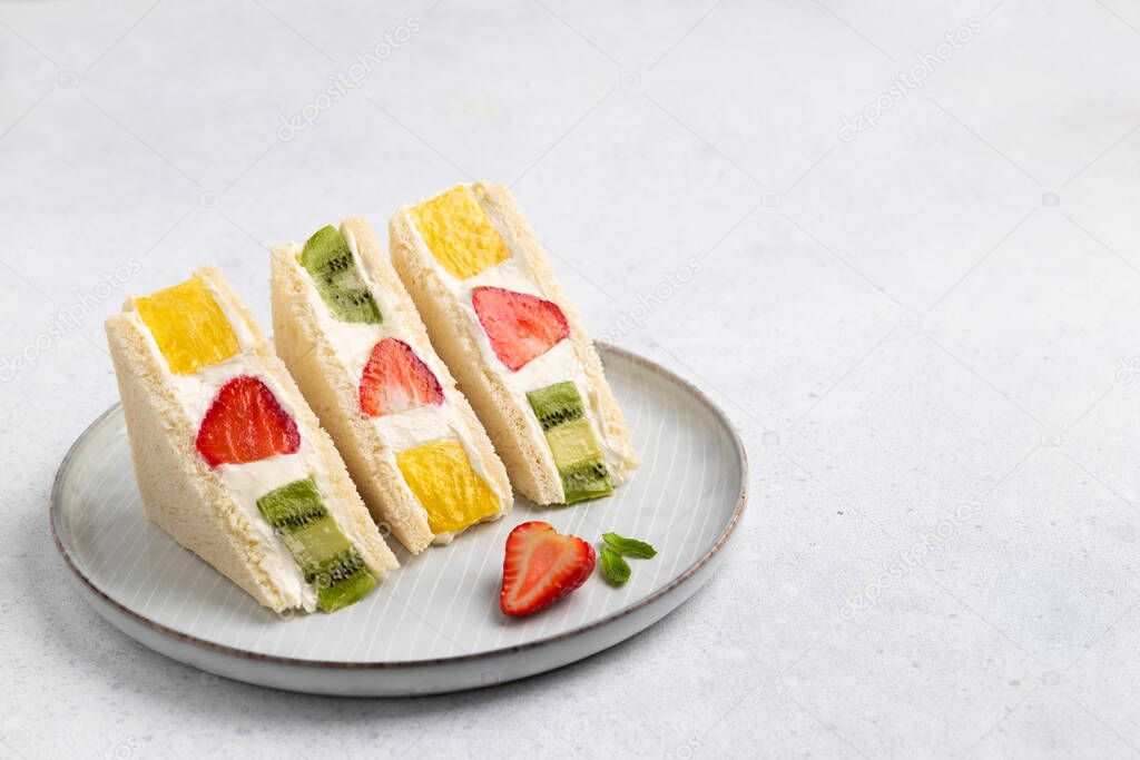 Japanese style sweet fruits sandwich with strawberry, pineapple and kiwi. Sweet homemade summer breakfast