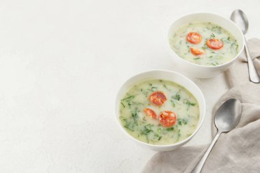 Two bowls of Portuguese style soup Caldo Verde on white background. Traditional Portuguese food