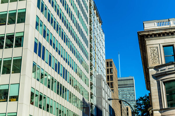Modern condo and business buildings with huge windows in Montreal downtown, Canada.