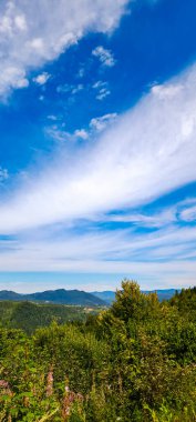 Dağları ve mavi gökyüzü olan güzel bir manzara.