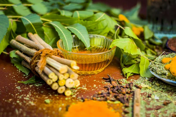 Ayurvedik tedavi için malzemeler görünümünü kapatın. Neem, neem bırakır, neem toz, ağaç kabuğu, karanfil, zerdeçal, su