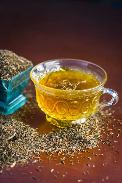 Schwarzkümmelsamen Und Ihr Tee Auf Hölzerner Oberfläche — Stockfoto
