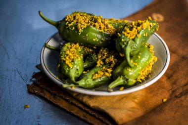 Green chilli peppers marinated in mustard seeds and mustard oil. clipart