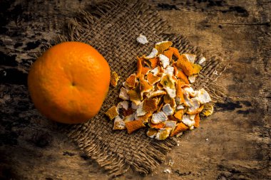 Close up of dried peel of orange on a gunny background clipart