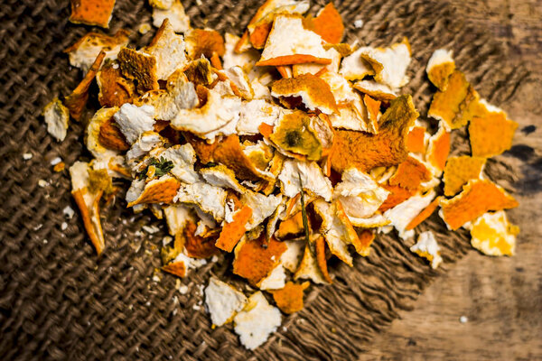 Close up of dried peel of orange on a gunny background