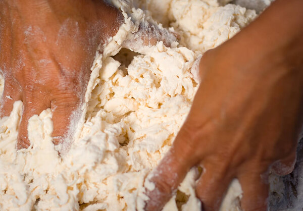 Close up view of a human hands making the dough of tan doori roti with maida flour or Cake flour