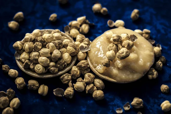 Close up of roasted chickpea and jaggery on blue background
