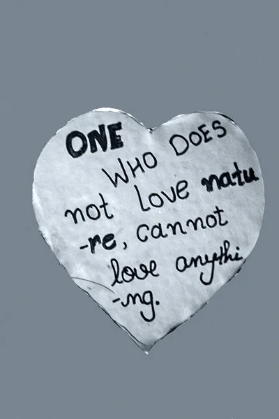 heart shaped paper sheet with handwritten lettering