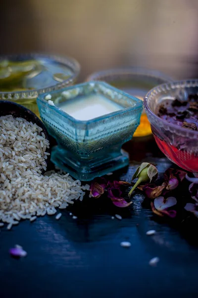 Face pack of rice flour with honey and rose water on wooden table