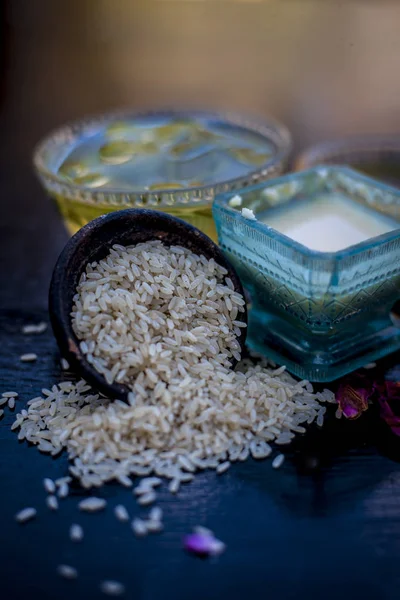 Face pack of rice flour with honey and rose water on wooden table