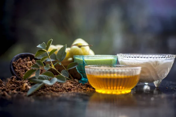 Herbal face pack of amla with yogurt and honey on wooden table