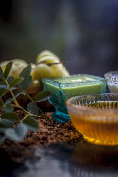 Herbal face pack of amla with yogurt and honey on wooden table