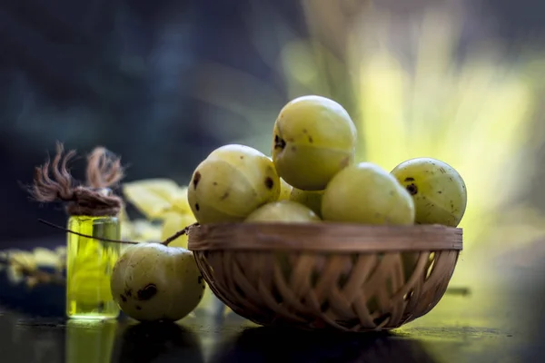 Indian gooseberry with extracted essence in transparent bottle