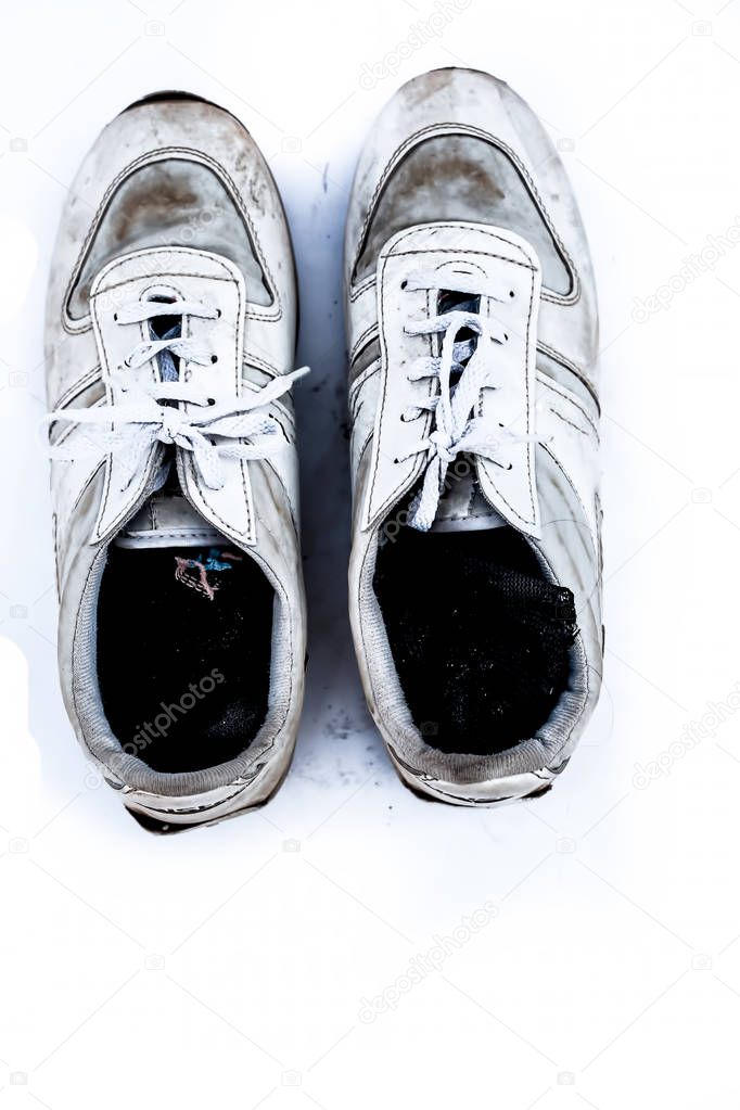 Close up of white colored men's sports shoes isolated on white.