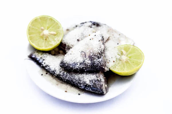Marinated fish with lime or lemon juice in a  glass plate isolated on white.