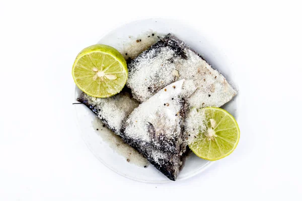 Marinated fish with lime or lemon juice in a  glass plate isolated on white.