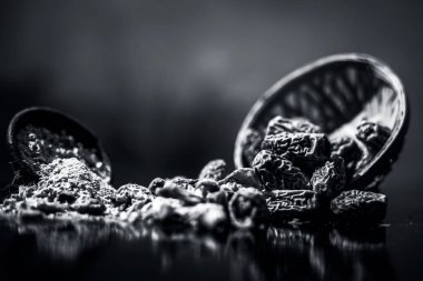 Ahşap yüzeyinde toz ile bir engel kurutulmuş hurma veya kharek veya sukhi khajoor yakın. siyah beyaz