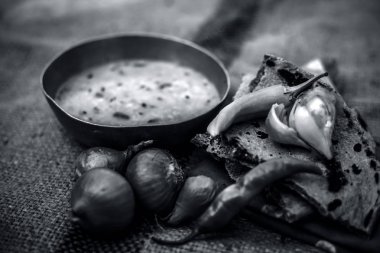 Beyaz mercimek ve onunla bazı soğan ve biber ile roti oluşan gunny çanta arka plan üzerinde zavallı adamın yemek yakın. siyah beyaz