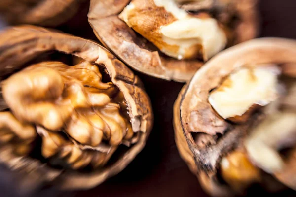 Macro shot of raw organic walnuts in sell on wooden surface.