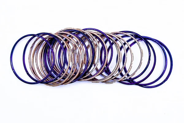 Beyaz üzerine izole edilmiş mor ve turuncu renkli metal bileziklerin yakın çekim.