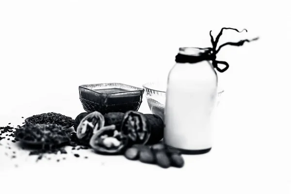 Close up of face mask or face pack of walnut along with flax seed or alsi, almonds,yogurt and milk in a glass bowl   entire raw ingredients isolated on white.