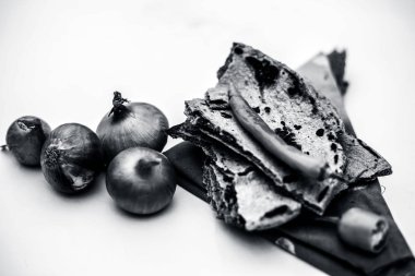 Yoksul adamın öğle yemeği veya çiftçinin öğle yemeği beyaz ya da ortak öğeleri yeşil biber ile birlikte kesilmiş ve çiğ soğan ile bajri ki roti beyaz izole yemiş izole.