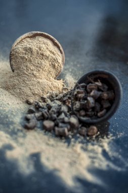 Popüler Hint & Asya ayurveda organik bitki musli veya Chlorophytum borivilianum veya Curculigo orkioidler veya kali moosli ahşap yüzeyüzerinde başka bir kase içinde toz ile bir kil içinde.