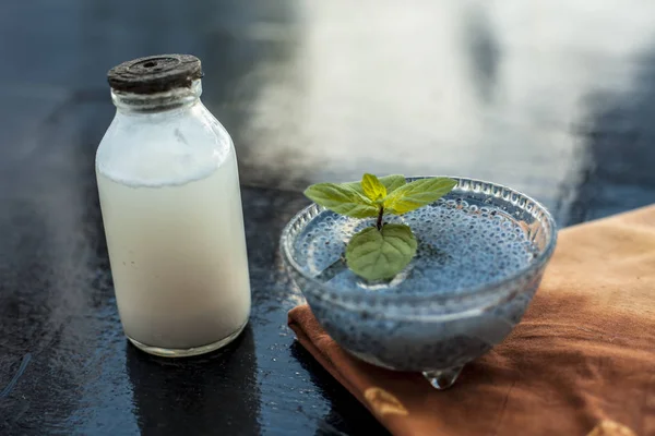Best home remedy to cure acidity or constipation on wooden surface consisting of sabja seeds or sweet basil seeds or basil seeds well mixed with raw milk.