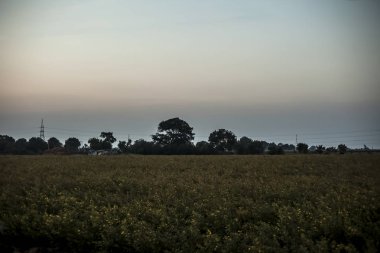 Dağların ve boş alanların gün batımı görüntüsü.