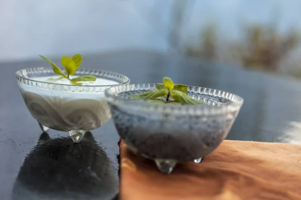 Best and most effective method to reduce weight i.e. Soaked sweet basil seeds well mixed in curd or yogurt.Entire raw ingredients on wooden surface.