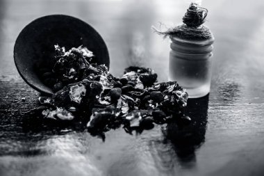 Kavrulmuş tohumları ile birlikte kil bir kapta demirhindi veya imli veya amli ve ahşap yüzeyüzerinde bir cam şişe esansiyel yağ ayıklamak.