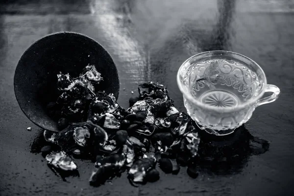 Kavrulmuş tohumları ile birlikte kil bir kapta demirhindi veya imli veya amli ve ahşap yüzey üzerinde nane veya mentha yaprakları ile şeffaf bir cam bardak çay ayıklamak.