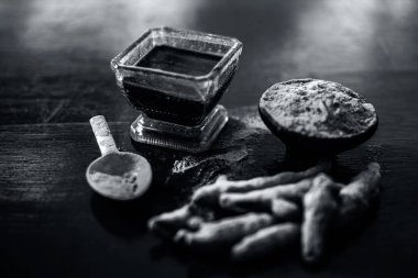 Akne ve sivilce tedavisinde kullanılan kil kase zerdeçal veya haldi ile ahşap yüzeyüzerinde kavrulmuş tohumları ile birlikte bir kil kase içinde demirhindi veya imli veya amli.