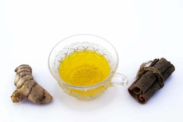 Popular turmeric tea isolated on white with its entire ingredients which are turmeric powder and raw, honey and cinnamon sticks.Used for detoxifying body.Isolated on white.